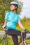 Portrait of young female caucasian cyclist athlete on bicycle ha