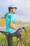 Portrait of young female caucasian cyclist athlete on bicycle ha