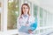 Portrait of a young female doctor with a stethoscope and folder on the consultation in clinic