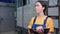 Portrait of a young female engineer records the meter readings on a tablet. Modern industry and manufacturing