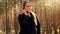 Portrait of young female hiker talking by phone while hiking in forest