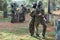 Portrait of young female paintball players with marker guns outdoors