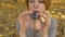 Portrait of young female shaman in beige dress with naked neck playing on ceramic ocarina in the forest during autumn