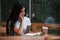 Portrait of young female student that sits in cafe at rainy day. One person only