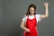 Portrait of young female supermarket employee holding full pockets