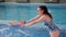 Portrait of young female swimming coach while working with children in the pool.