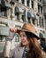 Portrait of a young female tourist with elegant clothes exploring the city