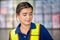 Portrait of young female warehouse worker standing in warehouse, Worker working in logistic industry inside factory warehouse