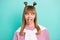 Portrait of young funky funny childish humorous girl stick tongue out with jumper on shoulders isolated on teal color