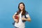 Portrait of young funny cute woman student in denim clothes with backpack blinking showing thumb up, hold school books