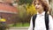 Portrait of a young genius. A schoolboy with a knapsack behind her, looks thoughtfully and seriously into the distance