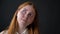 Portrait of young ginger teenage girl thinking and deciding, isolated on black background, expression of choosing