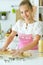 Portrait of young girl baking in the kitchen