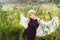 Portrait of young girl dancing in chamomile field