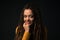 Portrait of a young girl with dreads on black background.