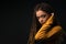 Portrait of a young girl with dreads on black background.