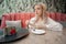 Portrait of young girl drinking coffee and thoughtfully looking while enjoying her leisure time alone, nice business