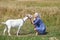 Portrait of a young girl with a goat in a wheat fieldess