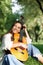 Portrait of a young girl guitarist who smiles and holds a guitar in her hands. Girl-musician, music, hobby