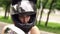 Portrait of young girl in a helmet on motorcycle.