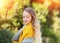 Portrait  of a young girl with luxurious wavy blond hair and blue eyes in a yellow scarf, October. Fashion and beauty.  Autumn