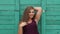 Portrait of a young girl overweight on the background of a green wooden fence.