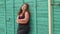 Portrait of a young girl overweight in the Park against the green wall. Girl XXL