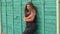 Portrait of a young girl overweight in the Park against the green wall. Girl XXL