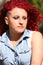 Portrait of a young girl with red curly hair and piercing, outdoor