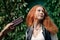 Portrait of young girl with red hair, refuse from chocolate bar