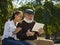 Portrait of young girl sitting with grandfather at park