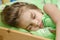 Portrait of young girl sleeping in bed