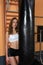 Portrait of young girl who is posing near punching bag in gym .