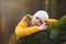 portrait of young girly in the forest, rest head on the tree