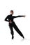 Portrait of young graceful male dancer, flexible man in black stage costume dancing ballroom dance isolated on white