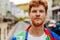 Portrait of young handsome calm redhead man in colorful shirt