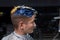 Portrait of a young handsome guy of European appearance in a hairdresser in the process of coloring his hair in blue and yellow