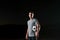 portrait of a young handsome soccer player man on a street playing with a football ball.