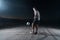 portrait of a young handsome soccer player man on a street playing with a football ball.