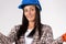 Portrait of young handywoman in a hard hat isolated on white. Gender stereotypes