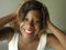 Portrait of young happy and beautiful black afro American woman posing charming and playful smiling cheerful looking to the camera