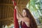 Portrait of young happy and beautiful red hair woman at aerial dancing workshop learning aero dance holding silk fabric smiling