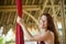 Portrait of young happy and beautiful red hair woman at aerial dancing workshop learning aero dance holding silk fabric smiling