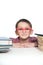 Portrait of a young happy boy in red spectacles with books.