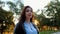 Portrait of young happy business woman in the city. Beautiful caucasian student girl in white blouse standing in