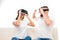 Portrait of young happy couple sitting on sofa using virtual reality headsets,