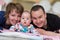 Portrait of young happy couple with their adorable baby boy