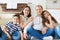 Portrait of young happy family with pretty teenager daughter and