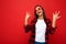 Portrait of young happy positive beautiful brunette woman with sincere emotions wearing white t-shirt, stylish red check