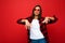 Portrait of young happy positive cool beautiful brunette woman with sincere emotions wearing white t-shirt, stylish red